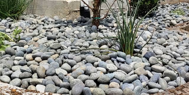River rocks installed for landscaping