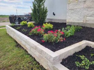 Installing a stone flower bed border in Frisco Texas
